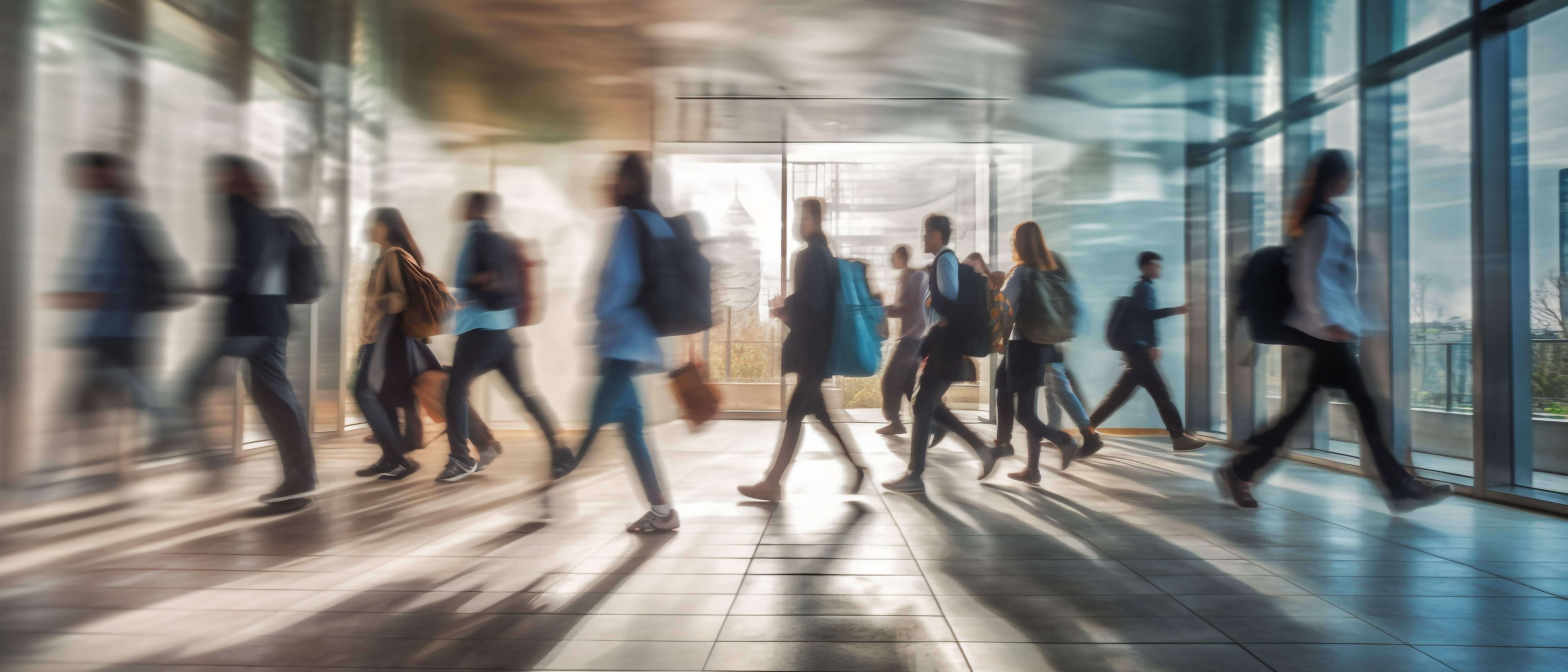 vecteezy_blurred_group_of_young_students_going_to_class_in_fast (1)